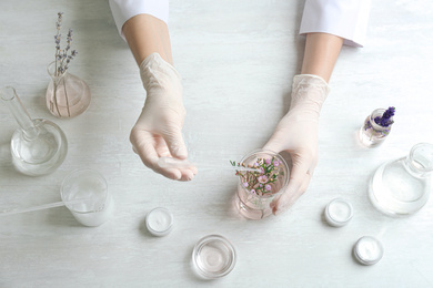 Photo of Scientist developing cosmetic product in laboratory, top view