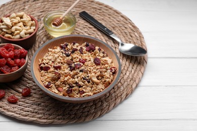 Photo of Tasty granola served with nuts and dry fruits on white wooden table. Space for text