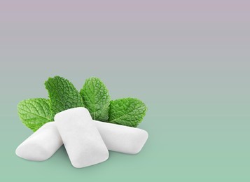 Image of Menthol chewing gum pillows and mint leaves on color gradient background, space for text