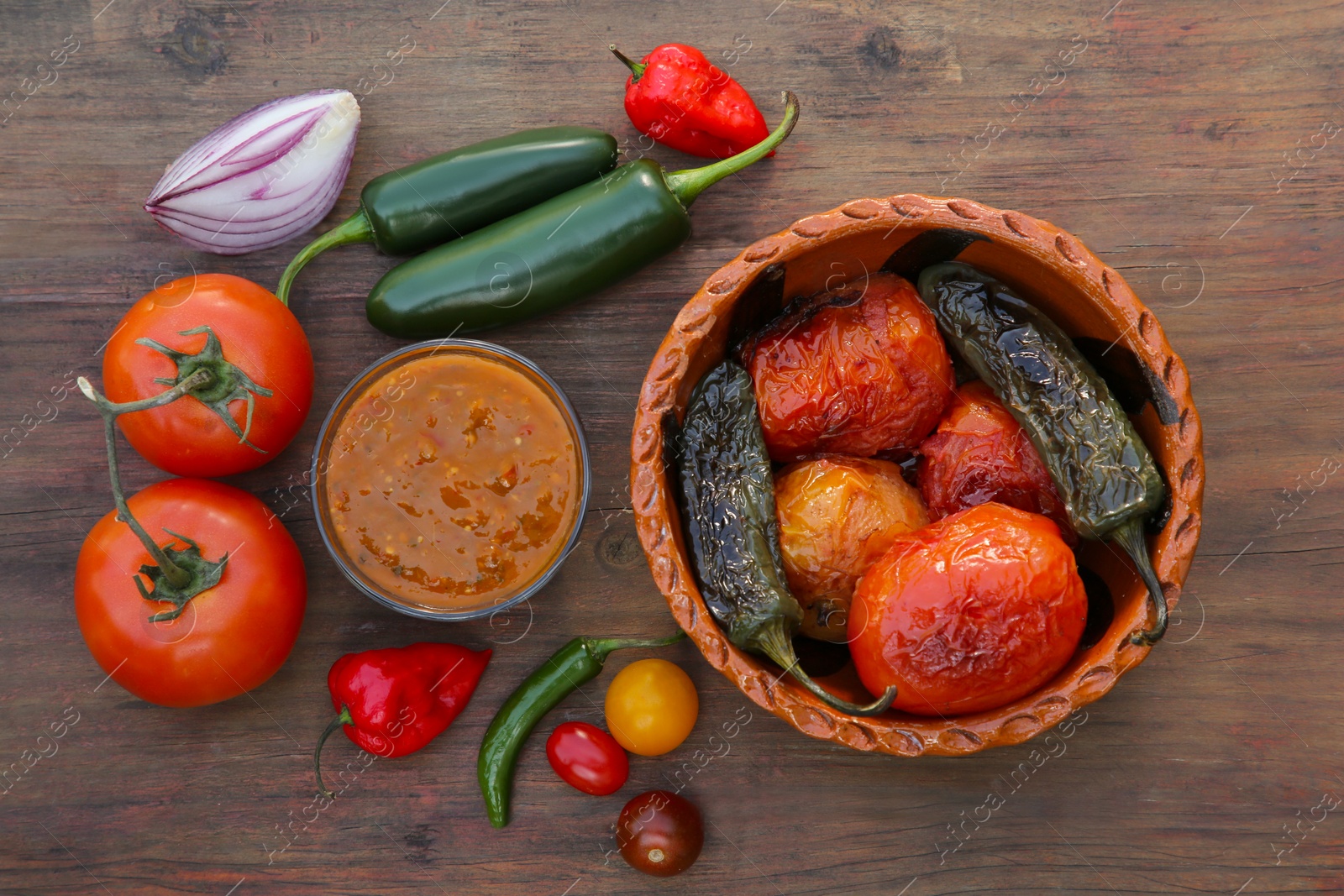 Photo of Tasty salsa sauce and ingredients on wooden table, flat lay