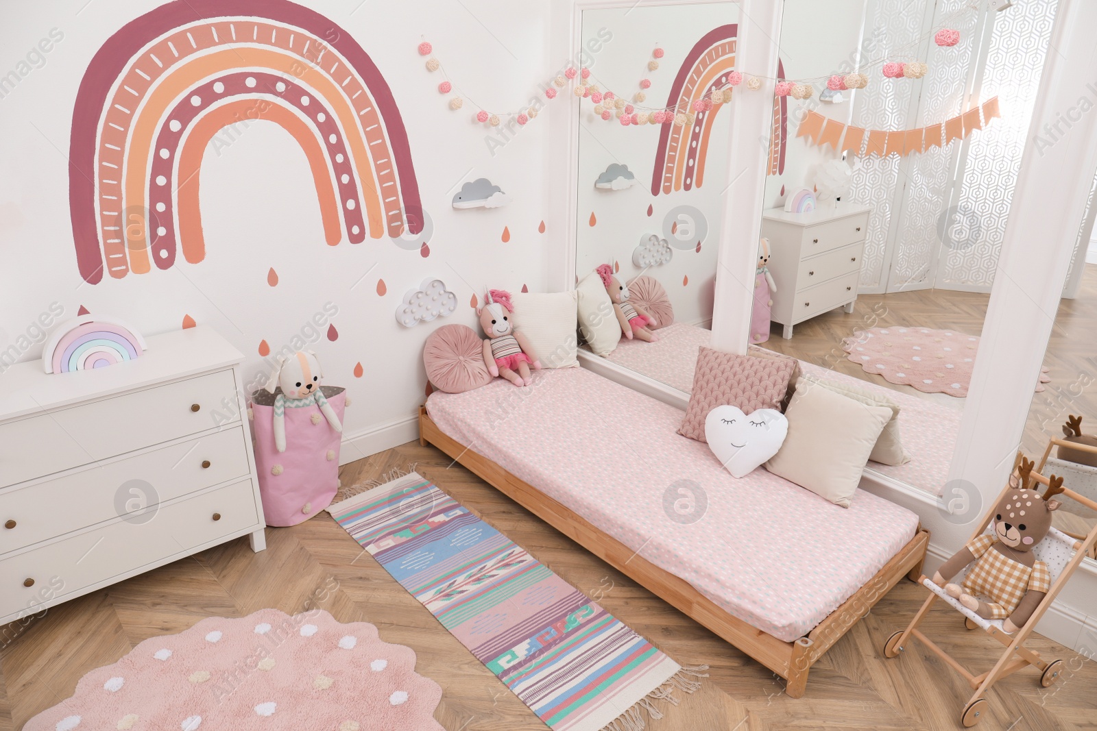 Photo of Montessori bedroom interior with floor bed and toys