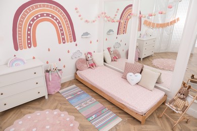 Photo of Montessori bedroom interior with floor bed and toys