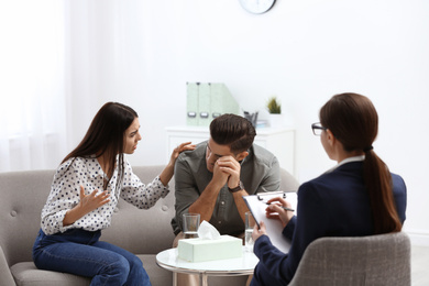 Photo of Professional psychologist working with couple in office