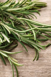 Sprigs of fresh rosemary on wooden table, closeup