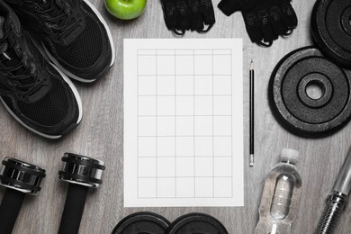 Photo of Workout plan, pencil and sports equipment on wooden table, flat lay. Personal training