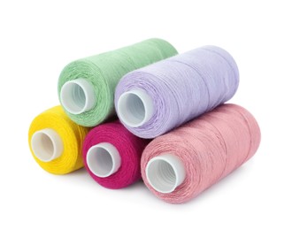 Photo of Different colorful sewing threads on white background