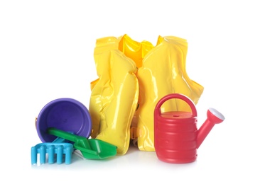 Photo of Inflatable vest and beach toys on white background