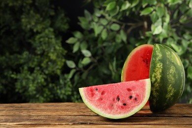 Photo of Delicious fresh watermelon slices on wooden table. Space for text