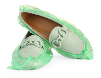 Photo of Women's mules in green shoe covers isolated on white