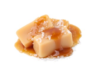 Photo of Yummy caramel candies and sea salt isolated on white