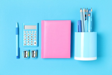 Photo of Different stationery on light blue background, flat lay. Back to school