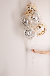 Photo of Woman holding bunch of balloons on white background, closeup