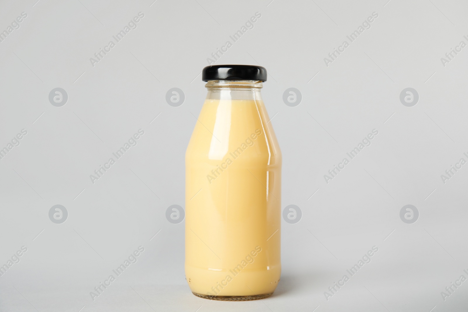 Photo of One bottle with tasty drink on color background