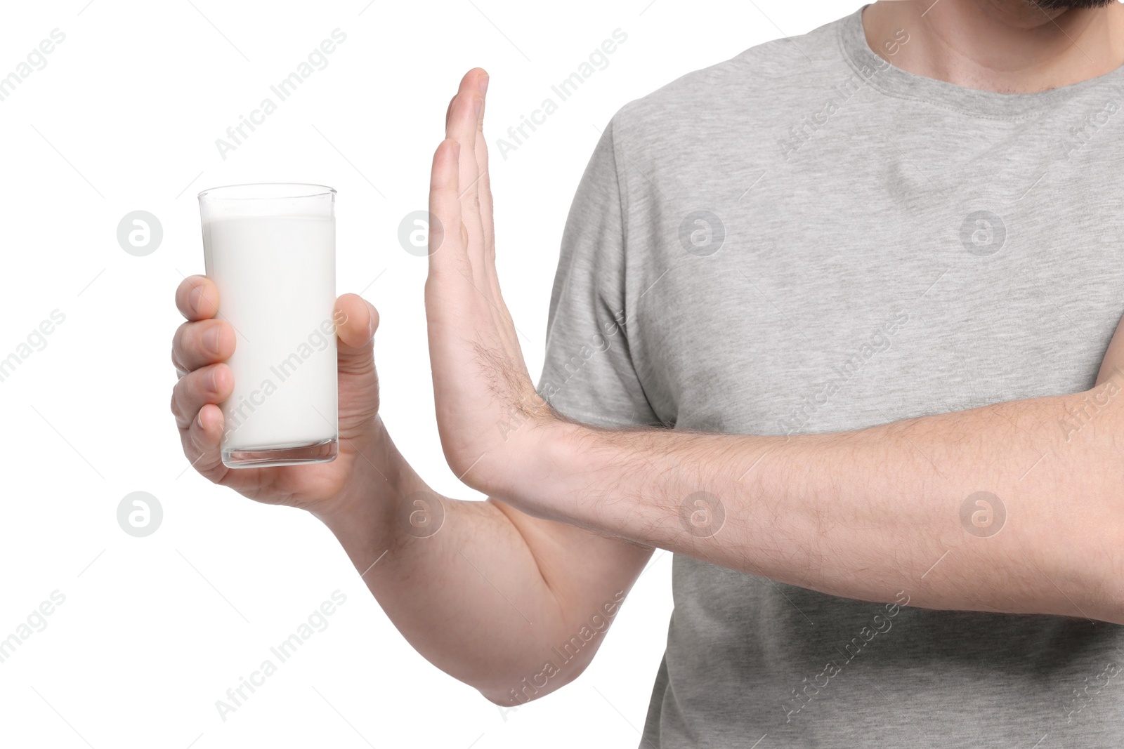 Photo of Man with glass of milk suffering from lactose intolerance on white background, closeup