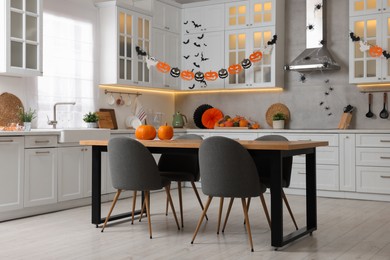 Photo of Stylish kitchen interior with festive decor. Halloween celebration