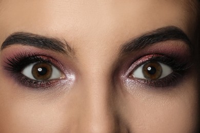 Photo of Young woman with evening makeup, closeup. Eye shadow product