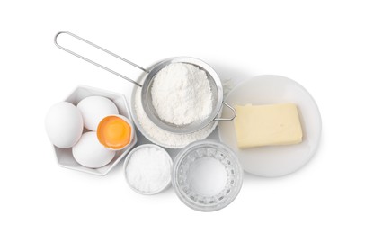 Eggs, butter, flour, salt and water isolated on white, top view. Ingredients for puff pastry dough