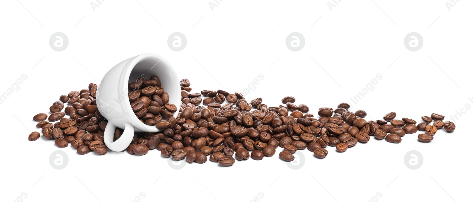 Photo of Overturned cup with roasted coffee beans on white background