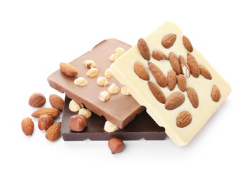 Photo of Different delicious chocolate bars with nuts on white background