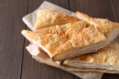 Delicious puff pastry on wooden table, closeup