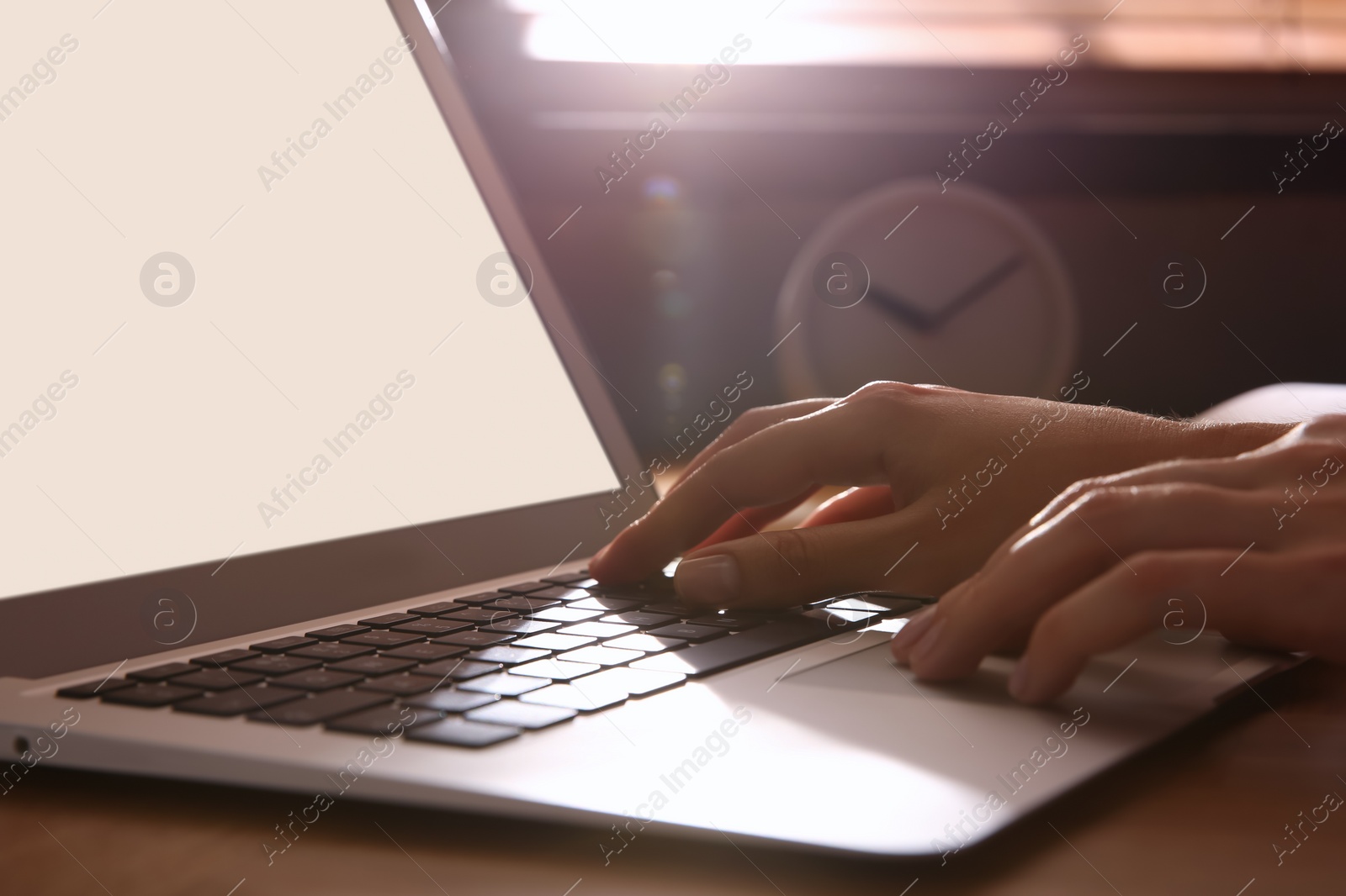 Photo of Woman using modern laptop at table indoors, closeup