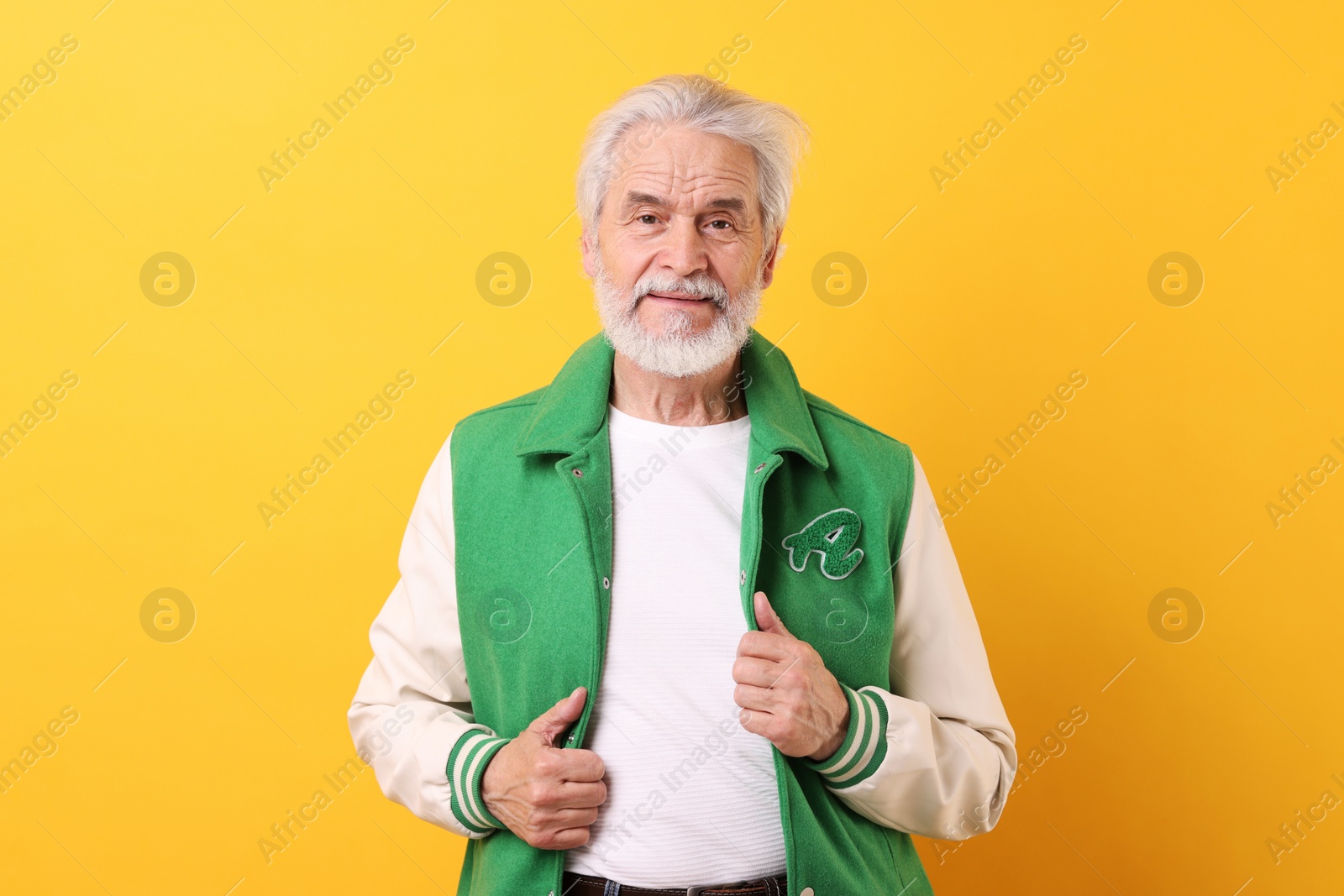 Photo of Portrait of stylish grandpa on yellow background