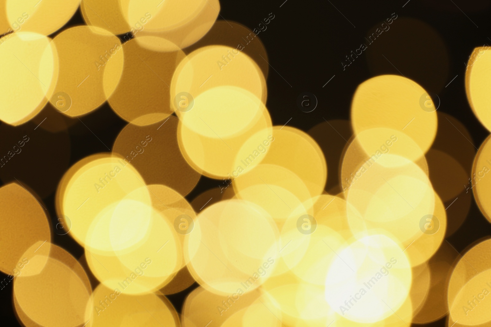 Photo of Blurred view of beautiful lights on black background. Bokeh effect