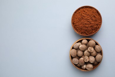 Nutmeg powder and seeds on white background, flat lay. Space for text