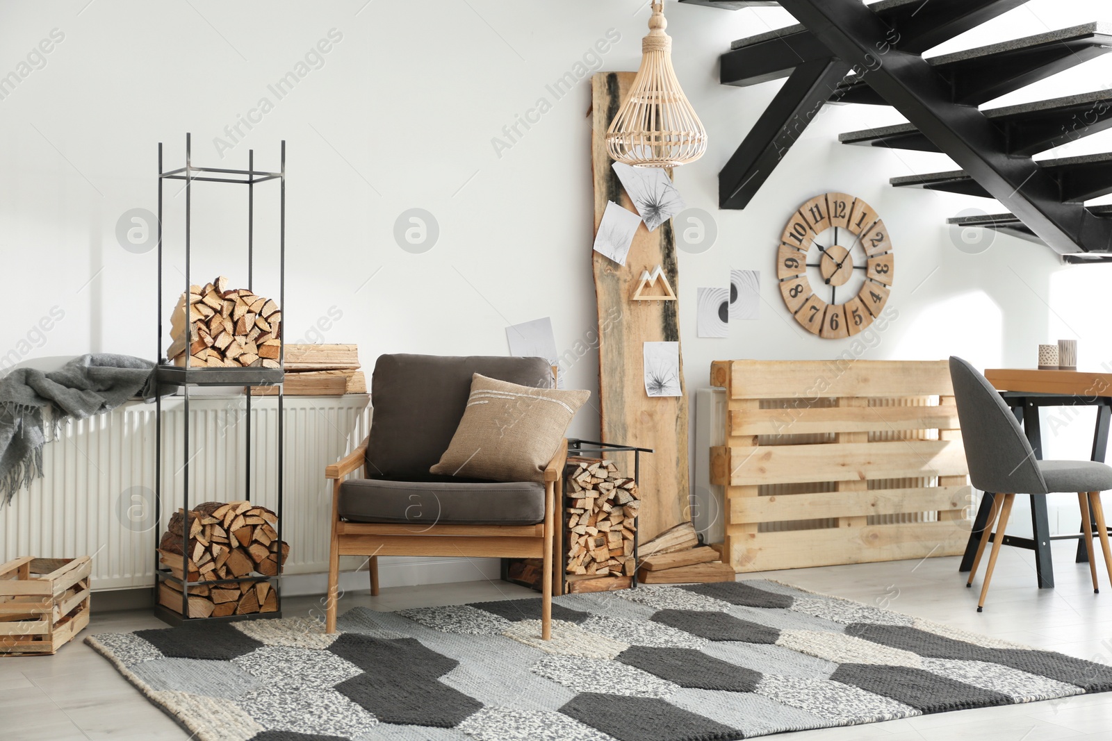 Photo of Stylish room interior with firewood as decorative element