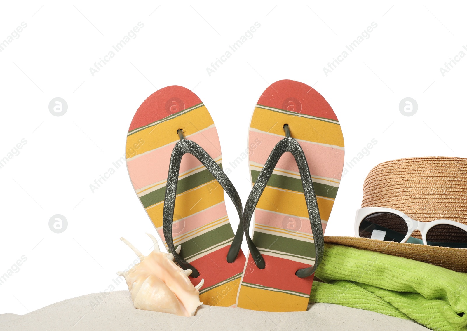 Photo of Different stylish beach accessories on sand against white background