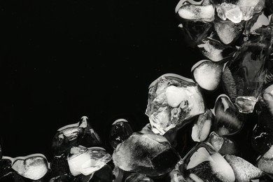Photo of Pieces of crushed ice on black background