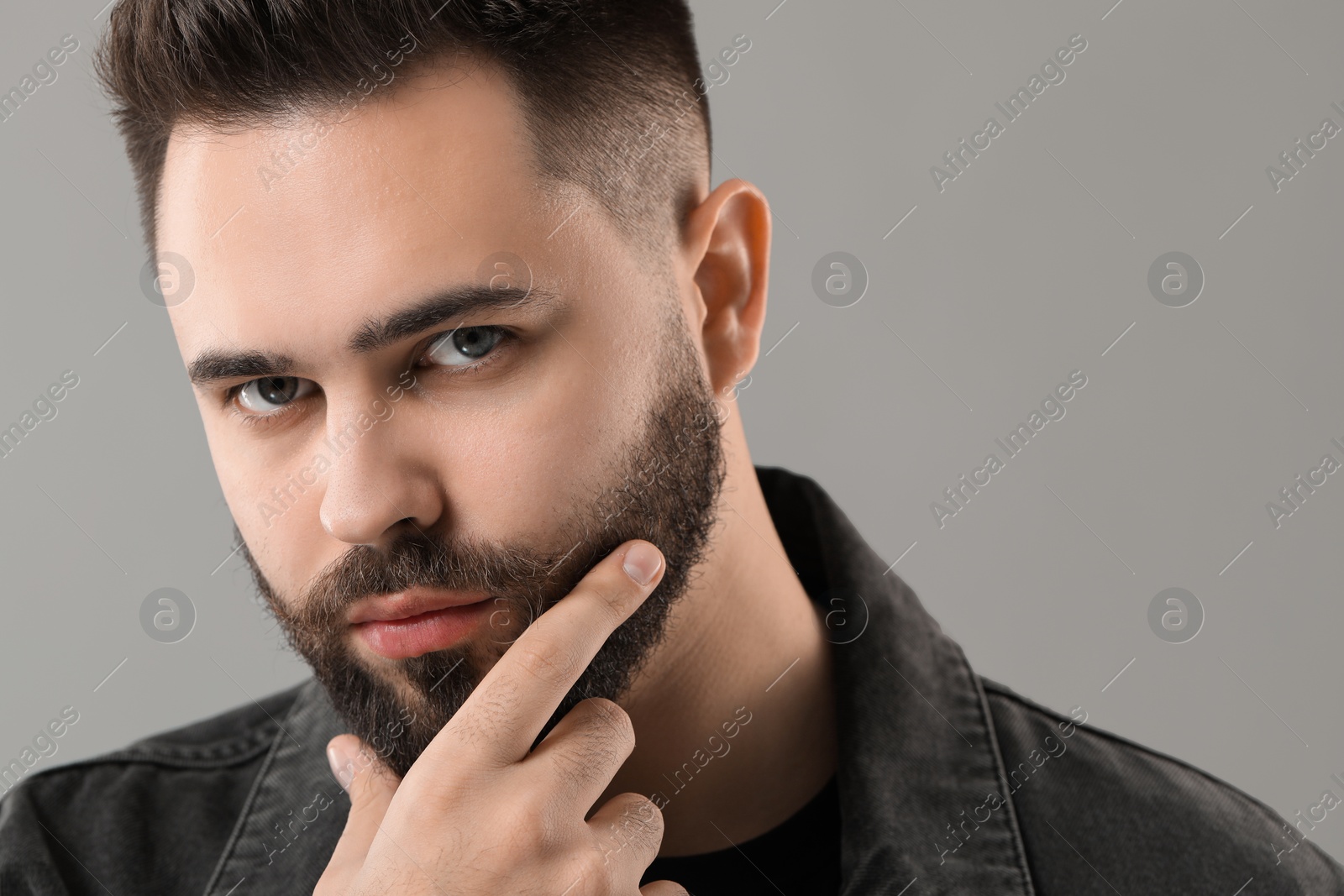 Photo of Young man with mustache on grey background