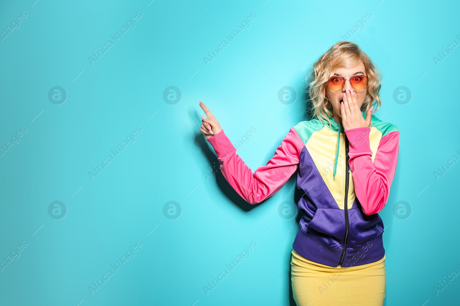 Photo of Emotional stylish young woman on color background