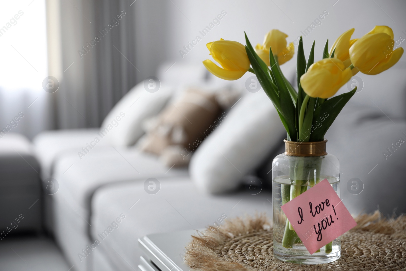 Photo of Sticky note with handwritten message I Love You attached to vase in living room, space for text