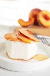 Photo of Delicious dessert with peach slices on plate