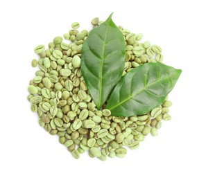 Green coffee beans and fresh leaves on white background, top view