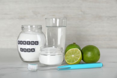 Composition with baking soda and toothbrush on white table