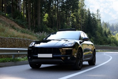 Picturesque view of asphalt road with modern black car outdoors