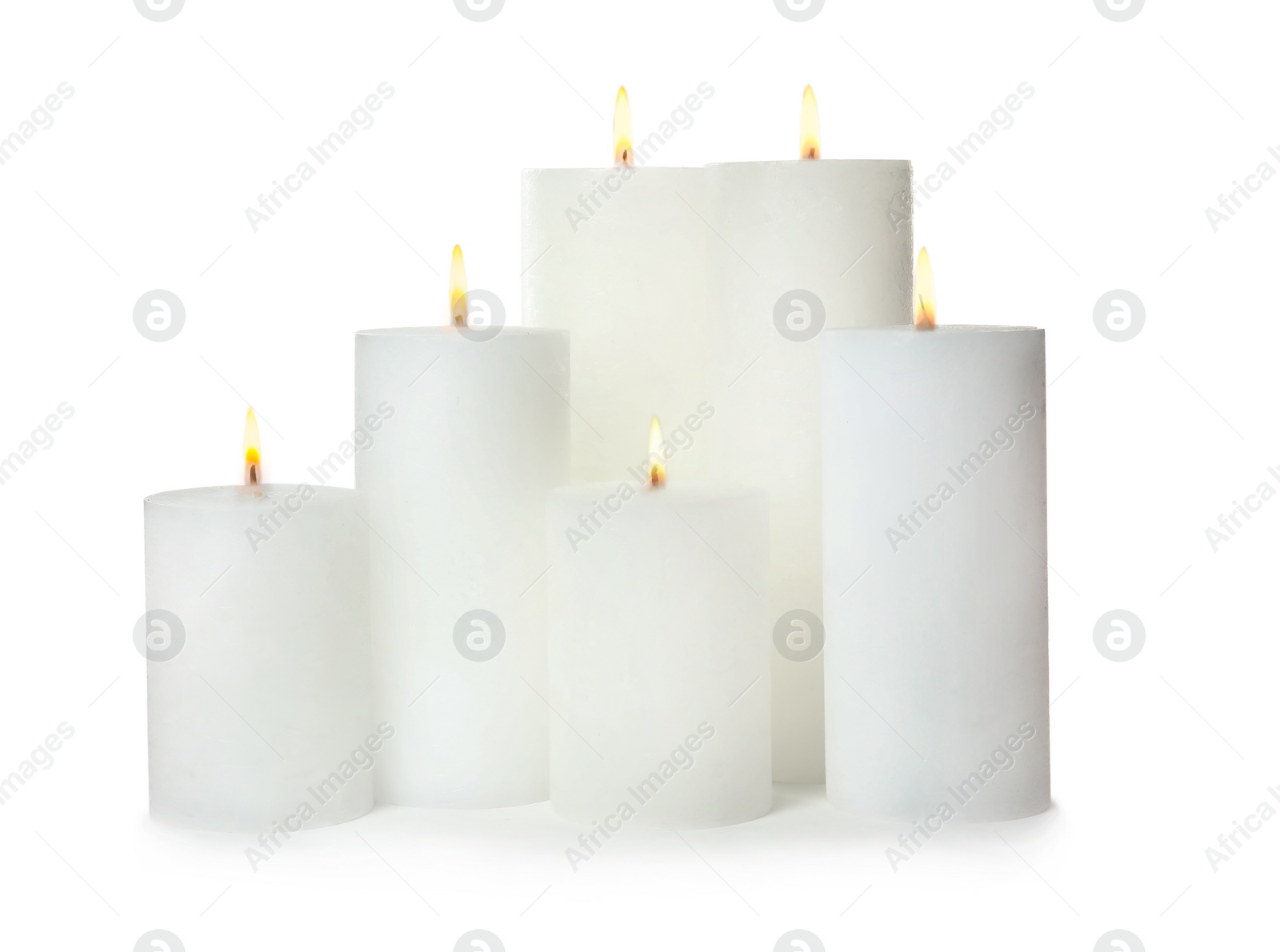 Photo of Many alight wax candles on white background