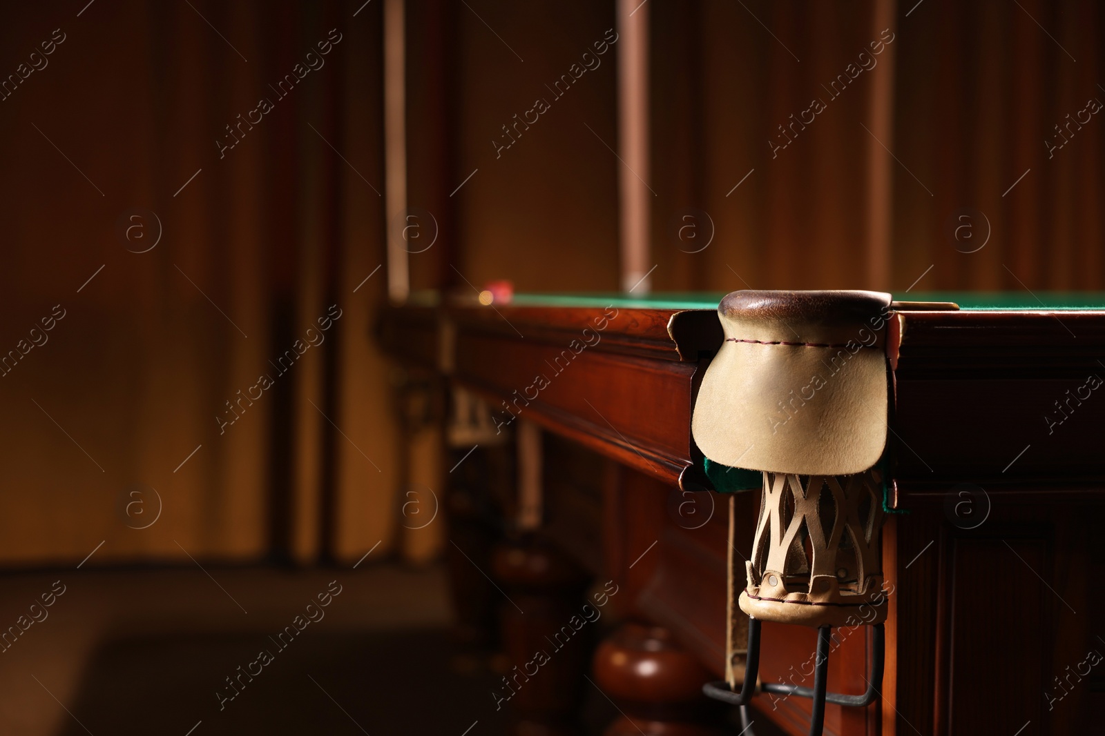 Photo of Stylish billiard table with pocket indoors, closeup. Space for text