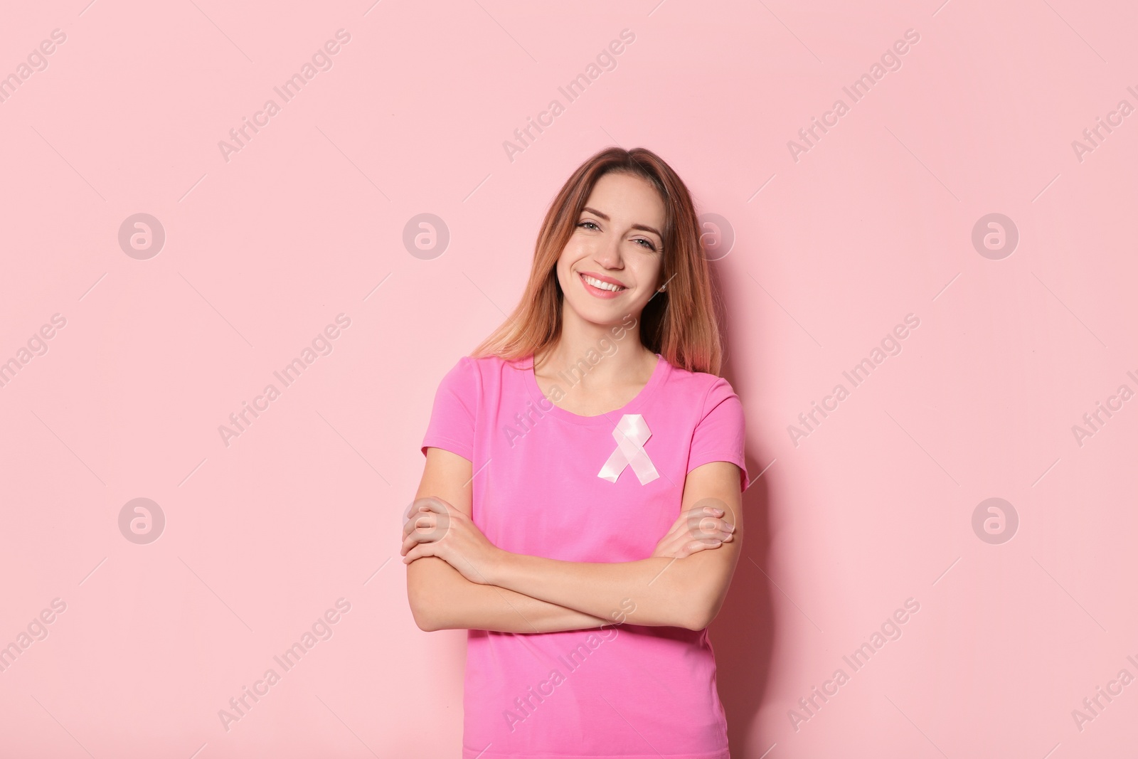 Photo of Woman with silk ribbon on color background. Breast cancer awareness concept