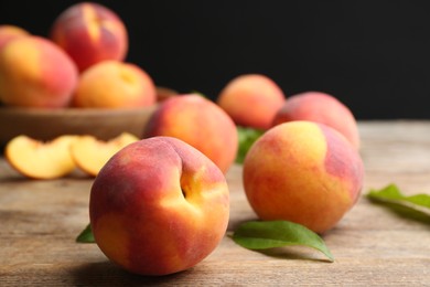 Photo of Fresh sweet peaches on wooden table, closeup