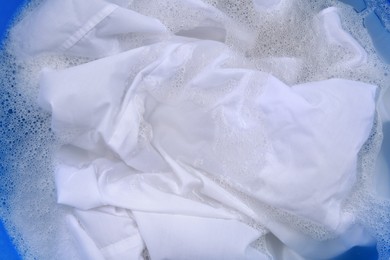 White garment in suds, closeup. Hand washing laundry