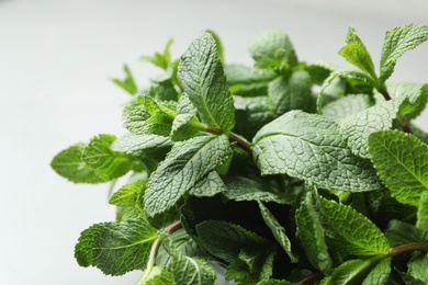 Photo of Fresh green mint on light background, closeup