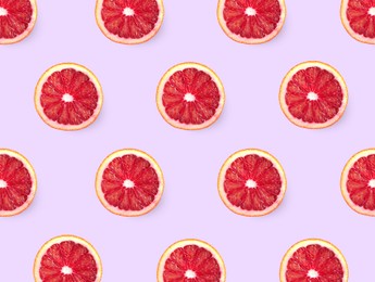 Image of Slices of red oranges on pink background, flat lay 