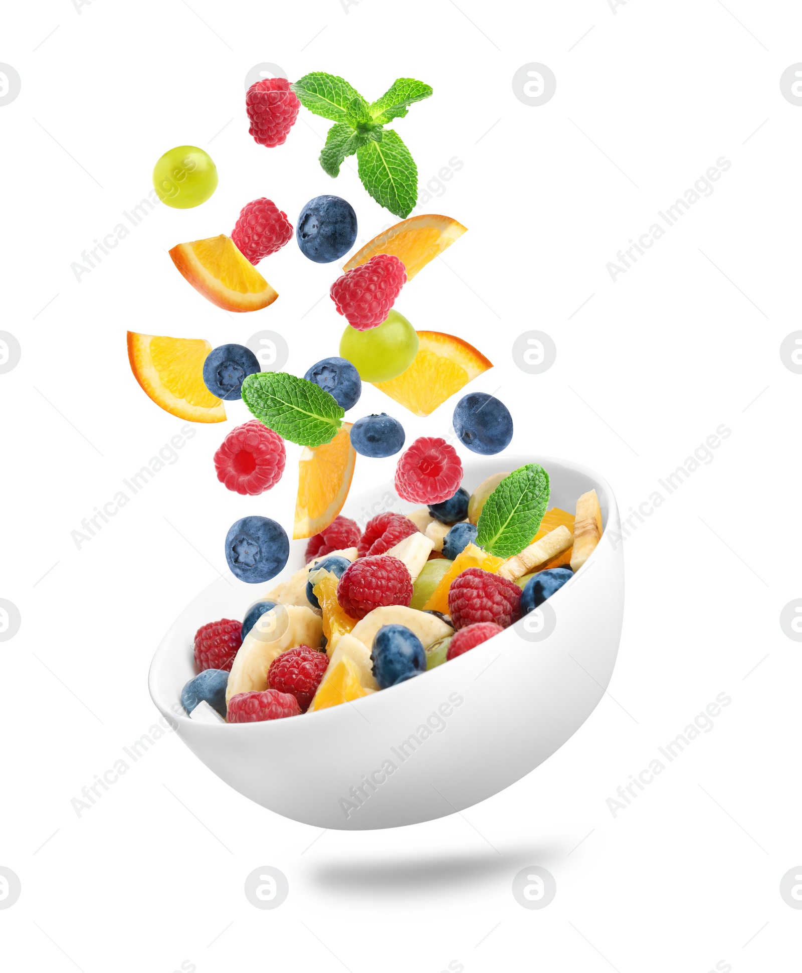 Image of Fresh ingredients for fruit salad falling into bowl on white background