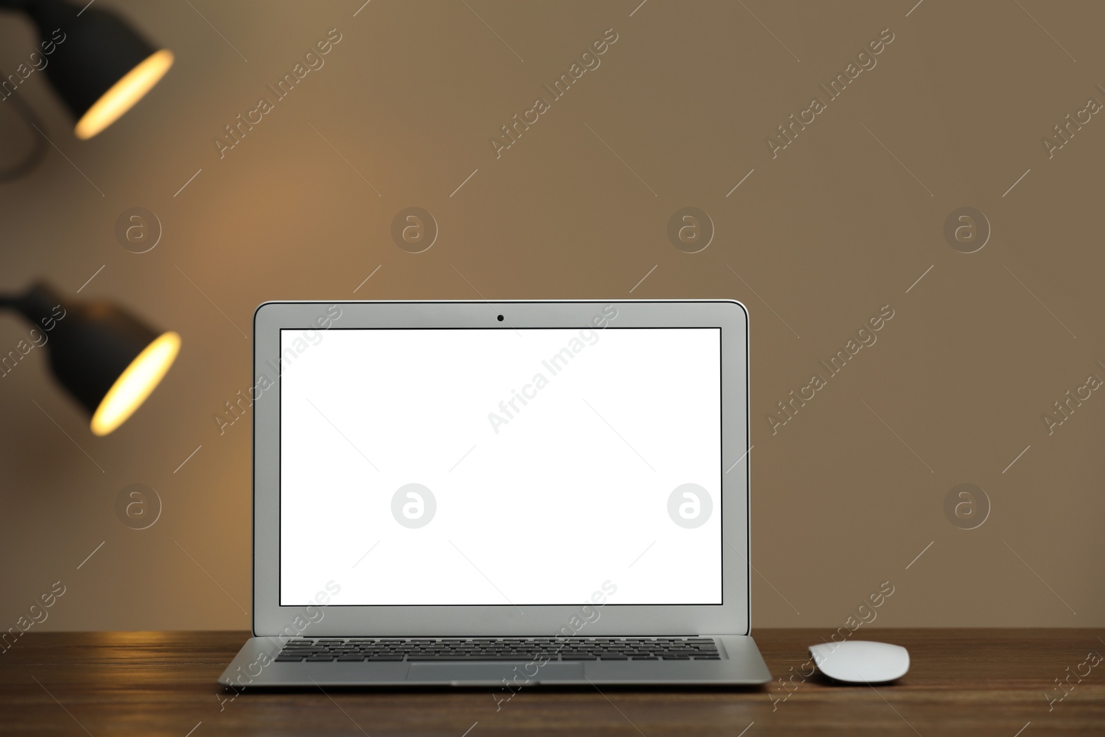 Photo of Laptop with blank screen on table indoors. Space for text