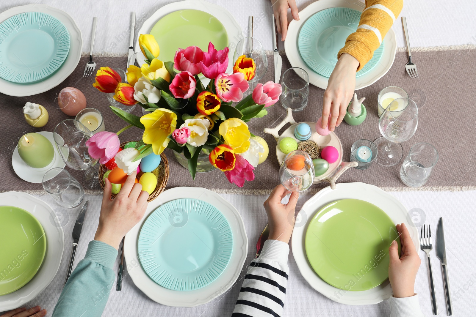 Photo of Festive table setting. Women celebrating Easter at home, top view