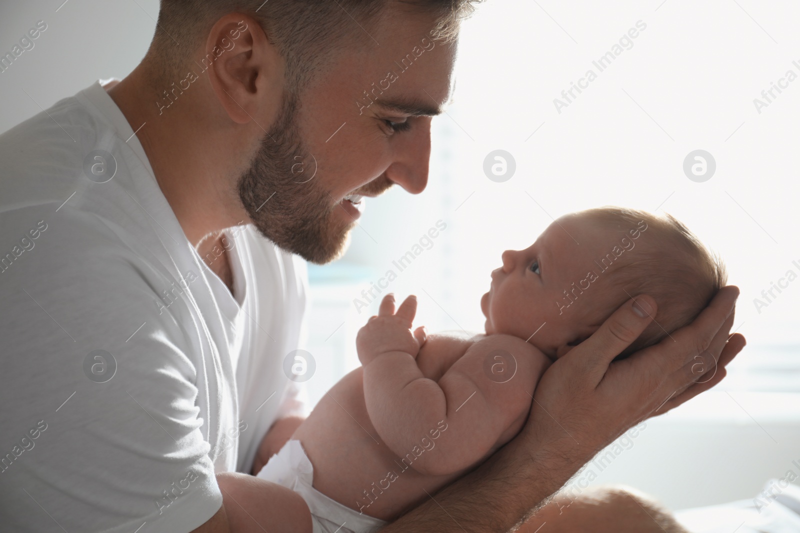 Photo of Father with his newborn son at home, closeup