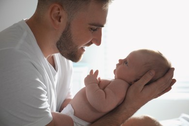 Photo of Father with his newborn son at home, closeup
